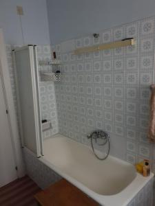 a white shower with a white refrigerator in a room at eleonora in Grottammare