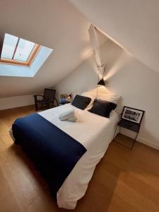 サン・ジャン・ド・リュズにあるDuplex T5 au pied de la plageのベッドルーム1室(屋根裏部屋に大型ベッド1台付)