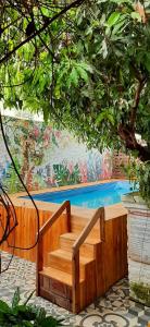 a wooden staircase in front of a swimming pool at Hotel Boutique Casa de Los Santos Reyes Valledupar in Valledupar
