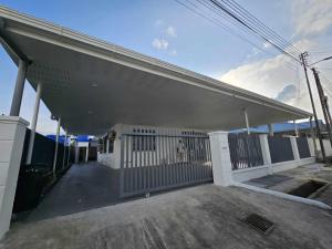 a garage with a white gate in a building at Grace Homestay in Kudat