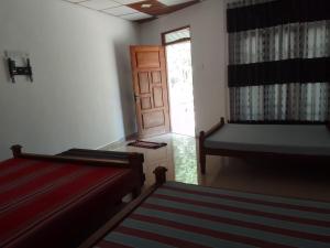Postel nebo postele na pokoji v ubytování Wilpattu Buma Lodge