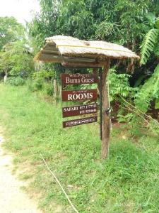 a sign in the grass next to a road at Wilpattu Buma Lodge in Pahala Maragahawewa