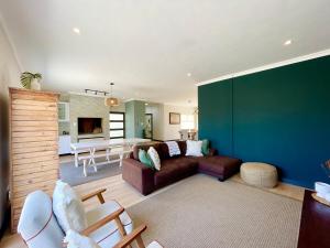 a living room with a couch and a table at Beachfront Corner View at Pebble Beach in Swakopmund