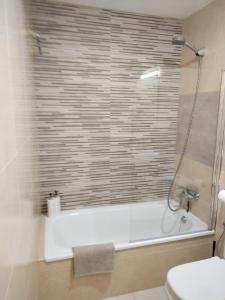 a bathroom with a shower and a tub and a toilet at Dúplex Chiclana Centro con Terraza y Parking By Chiclana Dreams in Chiclana de la Frontera