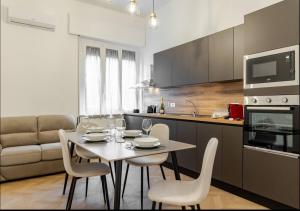 a kitchen with a table and chairs in a room at Residenza Camillo - Palermo Centro in Palermo