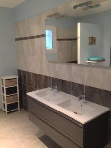a bathroom with a sink and a mirror at Belle maison avec piscine et terrain entièrement clôturé in Saint-Privat-de-Champclos