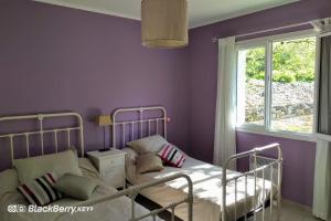 a purple bedroom with a bed and a window at Belle maison avec piscine et terrain entièrement clôturé in Saint-Privat-de-Champclos +20 photos