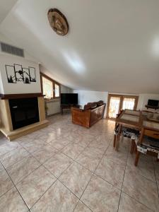 a large living room with a fireplace and a table at Maison Camigliati in Camigliatello Silano