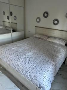 a bedroom with a large bed and a mirror at Guacimeta in Los Pocillos +12 photos