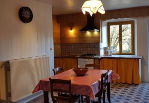 a kitchen with a table with a bowl on it at Grimont gîte au calme grand terrain circuit cascades du Hérisson in Saugeot
