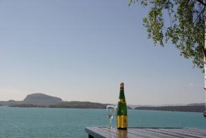 a bottle of wine and a glass sitting on a table at Koselig feriehus ved fjorden med panorama utsikt in Hjelmeland +9 photos