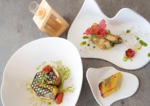 three white plates with different types of food on them at Fantinello Hotel in Caorle +37 photos