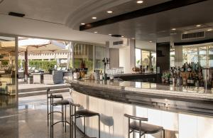 a bar in a restaurant with stools at Fantinello Hotel in Caorle