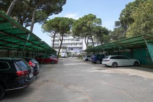a group of cars parked in a parking lot at Fantinello Hotel in Caorle
