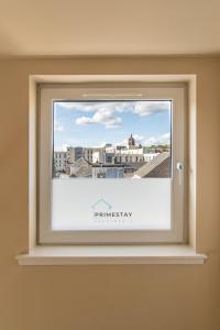 a window with a picture of a city at Prime Stay Apartments in Paisley