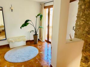 a living room with a chair and a rug at Villa - Sun and Moutain, Sa Murtera in Campanet +33 photos