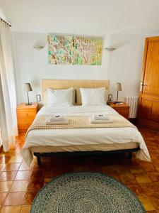a bedroom with a large bed with two pillows at Villa - Sun and Moutain, Sa Murtera in Campanet