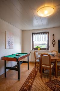 a room with a ping pong table and chairs at Ferienhaus Olbernhau 4 Sterne - Familie Walther in Olbernhau