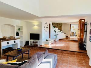 a living room with a couch and a fireplace at Villa - Sun and Moutain, Sa Murtera in Campanet