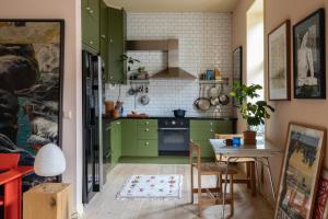 a kitchen with green cabinets and a table at The Residence in Oslo