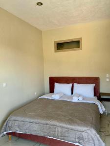 a bed in a room with two towels on it at Villa Athina 2 in Serres