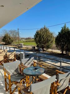 a patio with a table and chairs and a fence at Villa Athina 2 in Serres