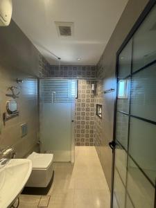 a bathroom with a shower and a toilet and a sink at شقة دار المنى الفندقية in Medina +19 photos