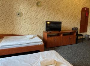 a room with two beds and a tv on a cabinet at Hotel i Restauracja Castle in Bystrzyca Kłodzka +124 photos