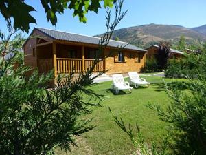 a house with two white chairs in a yard at PRL El Pastural in Err