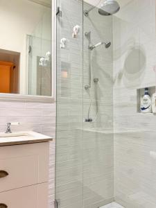 Un baño con ducha con puerta de cristal. en Kent St Townhouse, en Sídney