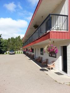 a building with a balcony with flowers on it at Mountain View Motel in Smithers