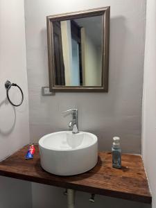 a bathroom sink with a mirror on a wooden counter at Casa Sonora Dunas Secure Parking in San Luis Río Colorado +13 photos
