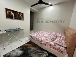 a living room with a bed and a couch at S&A Homestay in Sungai Petani