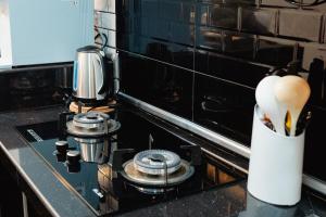 a kitchen counter with a stove with a mortar and pestle at S&A Homestay in Sungai Petani