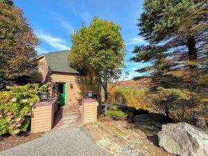 a house with a green door on a driveway at CR16 Ski-in/Out luxury home mountain views Bretton Woods in Bretton Woods