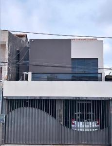 a building with a car in the middle of it at COP 30 Casa para 12 pessoas in Belém