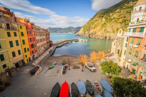 a view of a body of water between buildings at La Casa di Eroico Vino in Vernazza