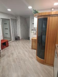 a living room with a large entertainment center at Šermukšnis in Rokiškis