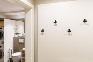 a bathroom with white doors and a toilet at KÖ-Gartensuite in Westerland +4 photos