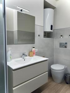 a bathroom with a sink and a toilet at Sanremo Bay Studio in Sanremo +3 photos