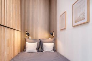 a bedroom with a bed with two pillows at L'héritage & SPA in Lyon