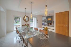 a kitchen with a glass table and some chairs at FRGK "VILLA La Cote D'Azur" in Cannes