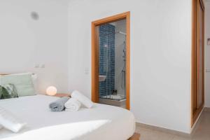 a white bed in a room with a mirror at Lagos Ocean View 2 With Pool by Homing in Lagos