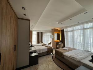 ein Hotelzimmer mit zwei Betten und einem Fenster in der Unterkunft Pars Palas Hotel in Bostaniçi
