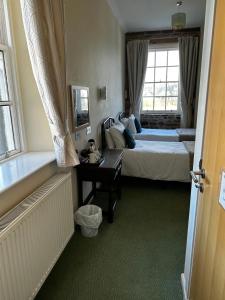Postel nebo postele na pokoji v ubytování Ecclefechan Hotel