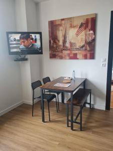 a dining room with a table and two chairs at F2 chez Cathy et Mike wittenheim in Wittenheim +4 photos
