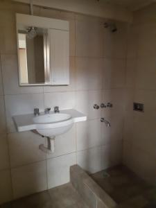 a bathroom with a sink and a mirror at Casa Escalera Caracol in Buenos Aires +20 photos