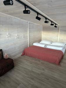 a bedroom with a red bed in a room at Country House in Almaty