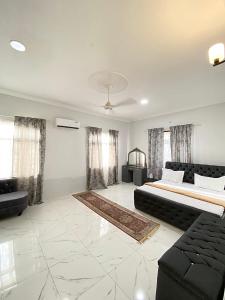 a large living room with a bed and a couch at HalmaHome in Chukwani