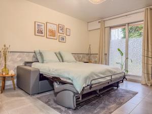 a large bedroom with a bed and a window at Villa Bel Air - appartement avec jardin et parking in Chartres